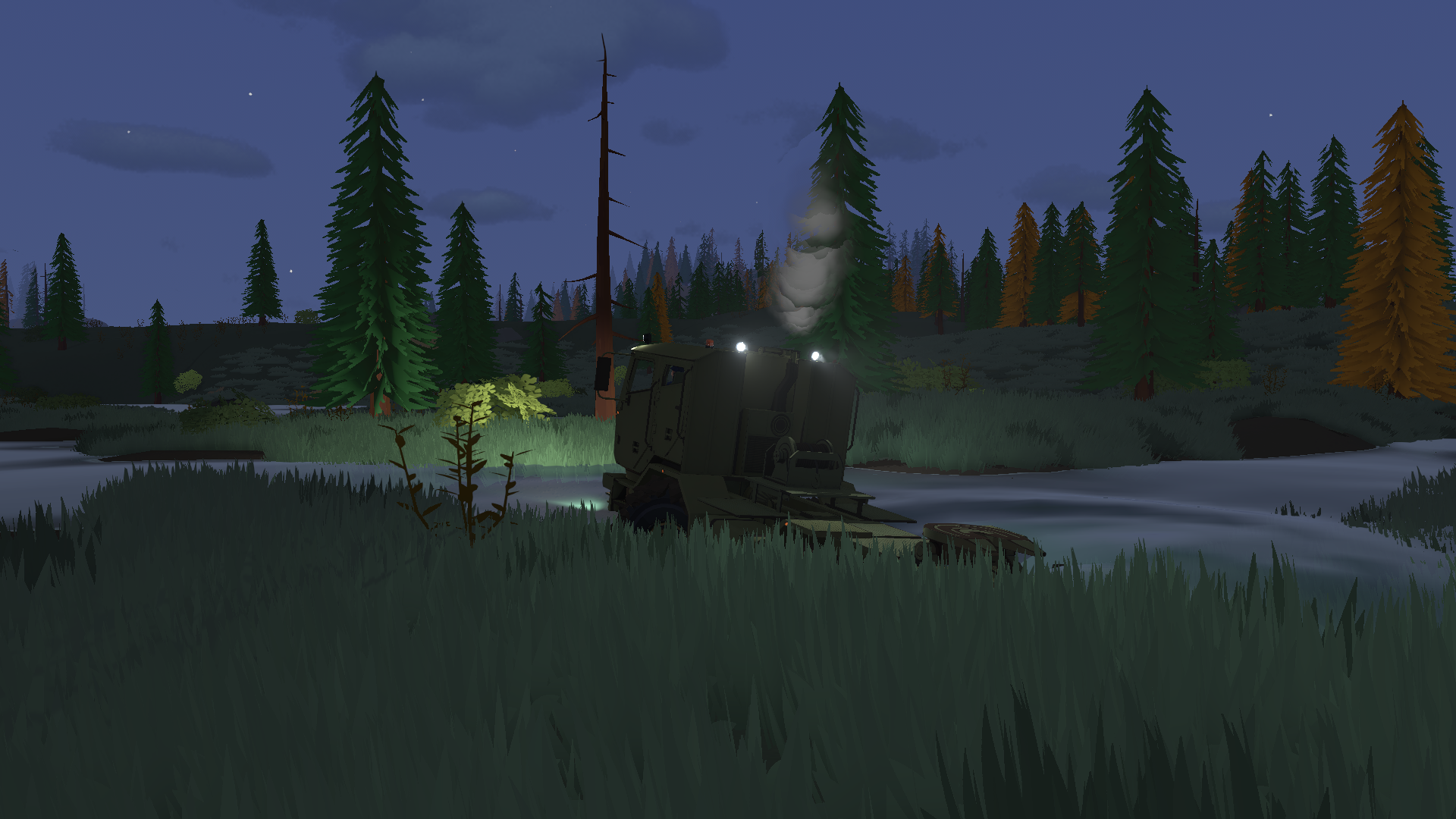 A heavy truck with its lights on beside water at night